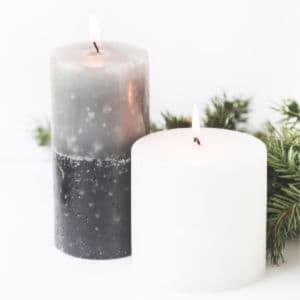 lighted candles and holiday greenery