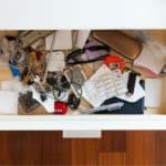 open drawer with various items inside. junk drawer