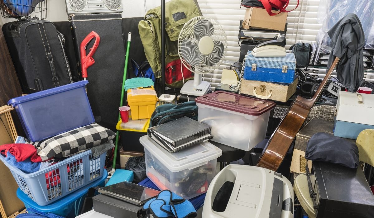 decluttering tips for hoarders-piles of unused stuff thrown in a room
